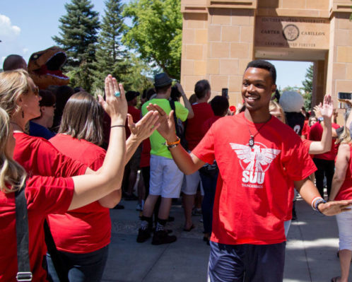 Carter Carillon Tradition, new students walk from the America First Event Center at the conclusion of their Welcome Assembly to the Upper Quad and pass underneath the Carter Carillon where they are officially welcomed to the University by returning students, administration, faculty, staff and alumni.