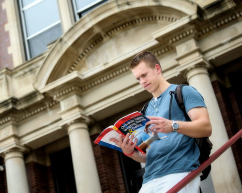 Student reading Orthopedic textbook at Minot State University