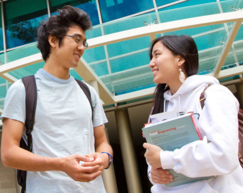 Students talking on campus at the University of Hawaiʻi at Mānoa