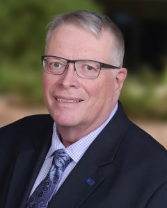 Headshot of Dennis Mohatt.